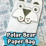 Completed polar bear craft made with a white paper bag and cardstock.