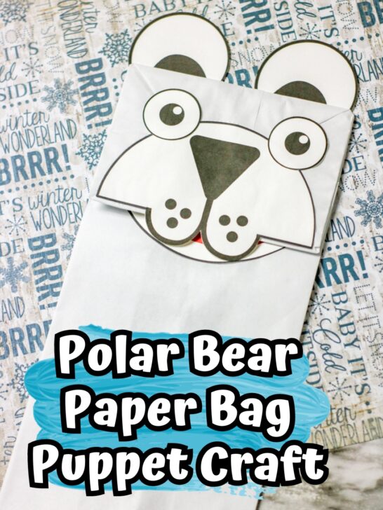 Completed polar bear craft made with a white paper bag and cardstock.