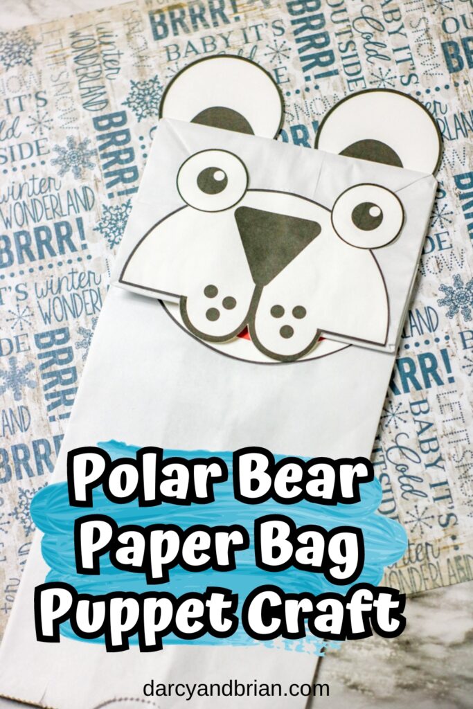 Completed polar bear craft made with a white paper bag and cardstock.