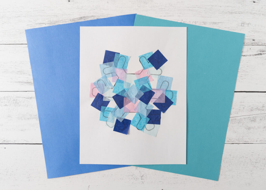 Snowflake template covered in blue and pink tissue paper.
