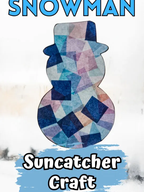 Completed snowman suncatcher craft made with tissue paper in a sunny window during winter.