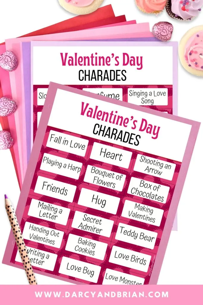 Mockup of Valentine's Day charades printable cards laying on pink and purple papers.