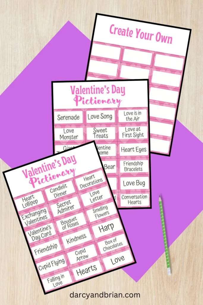 Mockup of all three printable Valentines Pictionary pages overlapping each other on a purple paper and desk background.