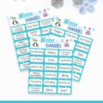 Mockup with three pages of winter themed charades overlapping each other on a white background. Top of image is decorated with snowflakes. Bottom of image has white text on dark teal background that says Winter Charades.