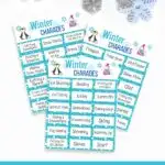 Mockup with three pages of winter themed charades overlapping each other on a white background. Top of image is decorated with snowflakes. Bottom of image has white text on dark teal background that says Winter Charades.