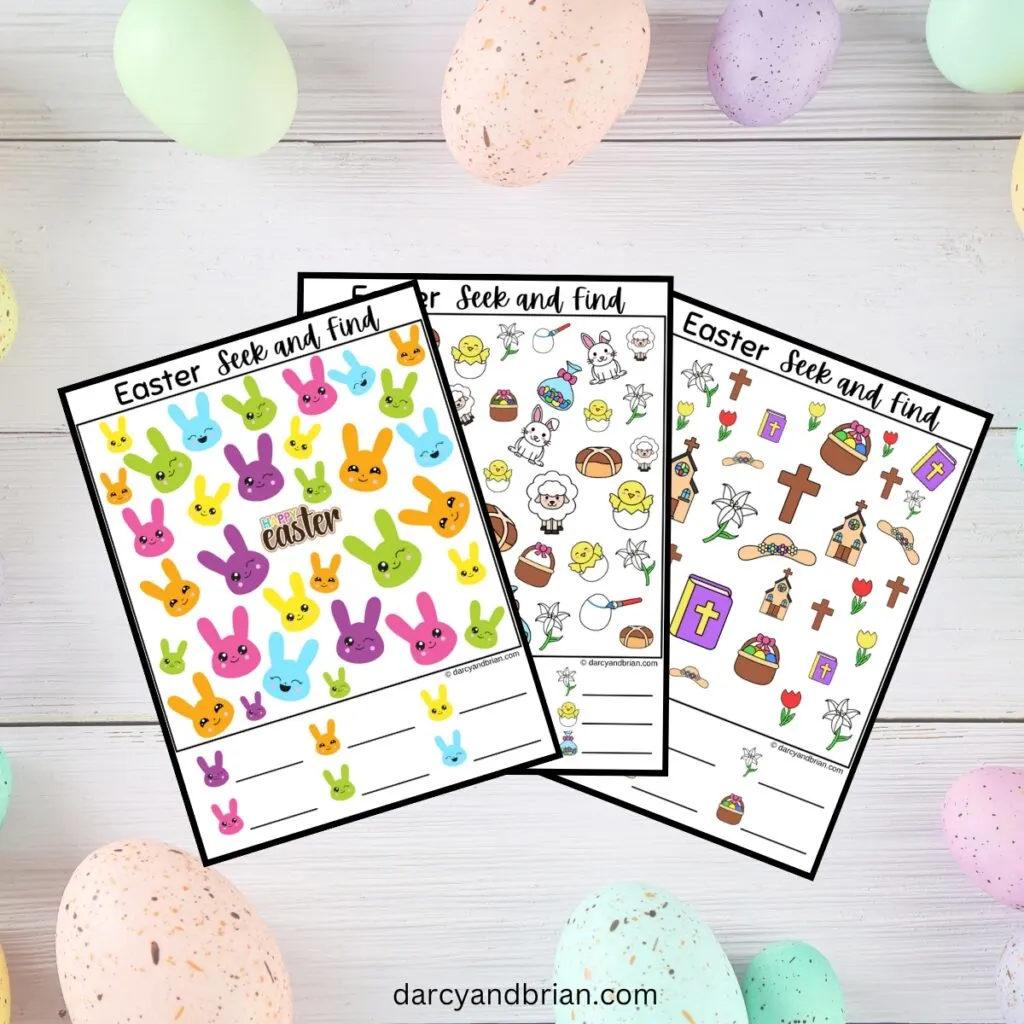 Three pages of i Spy Easter pages overlapping each other on a white wood background with pastel Easter eggs.