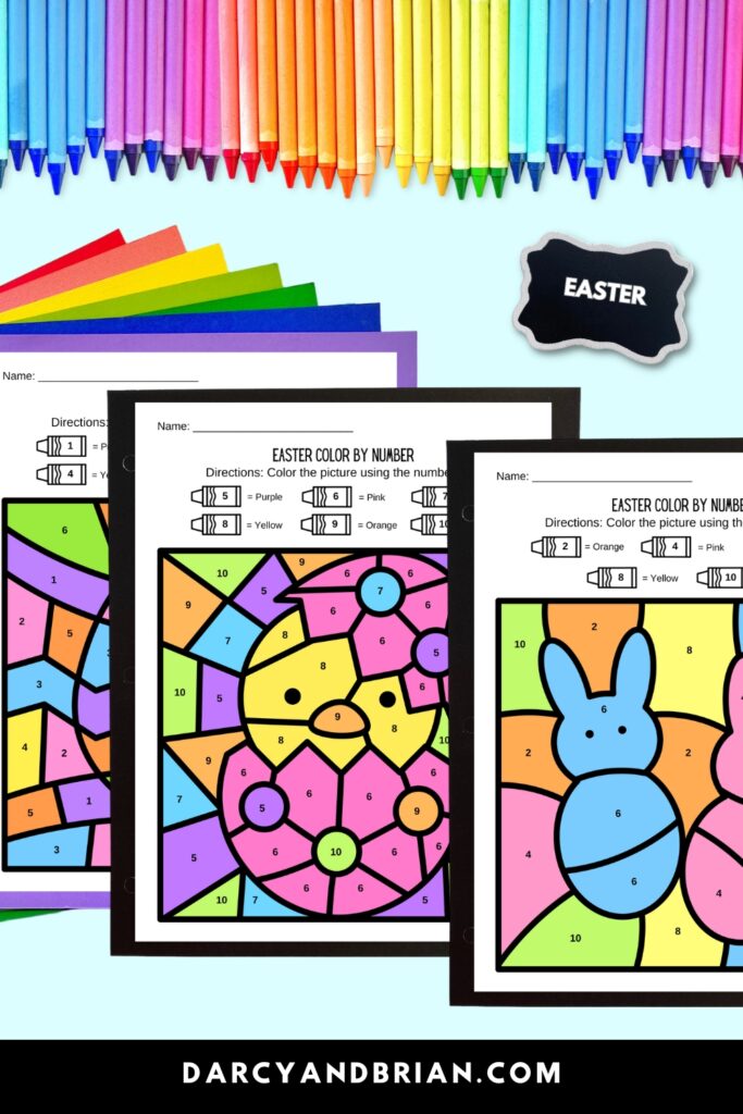 Three pages of Easter themed color by number worksheets in a mockup that is decorated with a rainbow of papers and crayons behind the pages.
