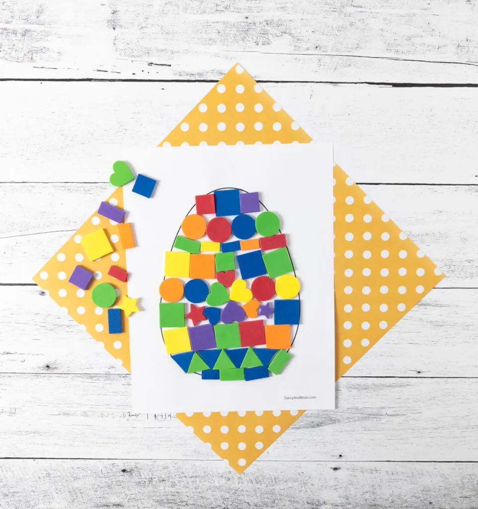 Easter egg mosaic made with foam peel and stick shapes in a variety of rainbow colors.
