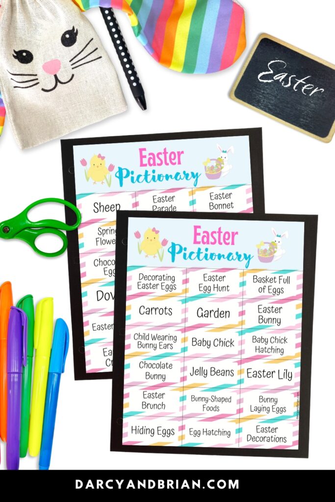 Preview images of two pages of Easter Pictionary word lists on top of black paper, overlapping each other. Markers, scissors and a small chalkboard that says Easter around the pages.