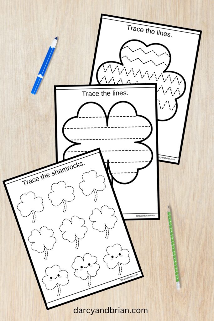 Preview of three shamrock tracing pages overlapping each other. A small marker and a pencil laying on the table next to them.
