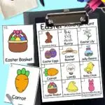 Easter themed scavenger hunt on a black clipboard with two cards next to the clipbard. Scissors next to the card. Bunny bag, pen, crayons along the top.