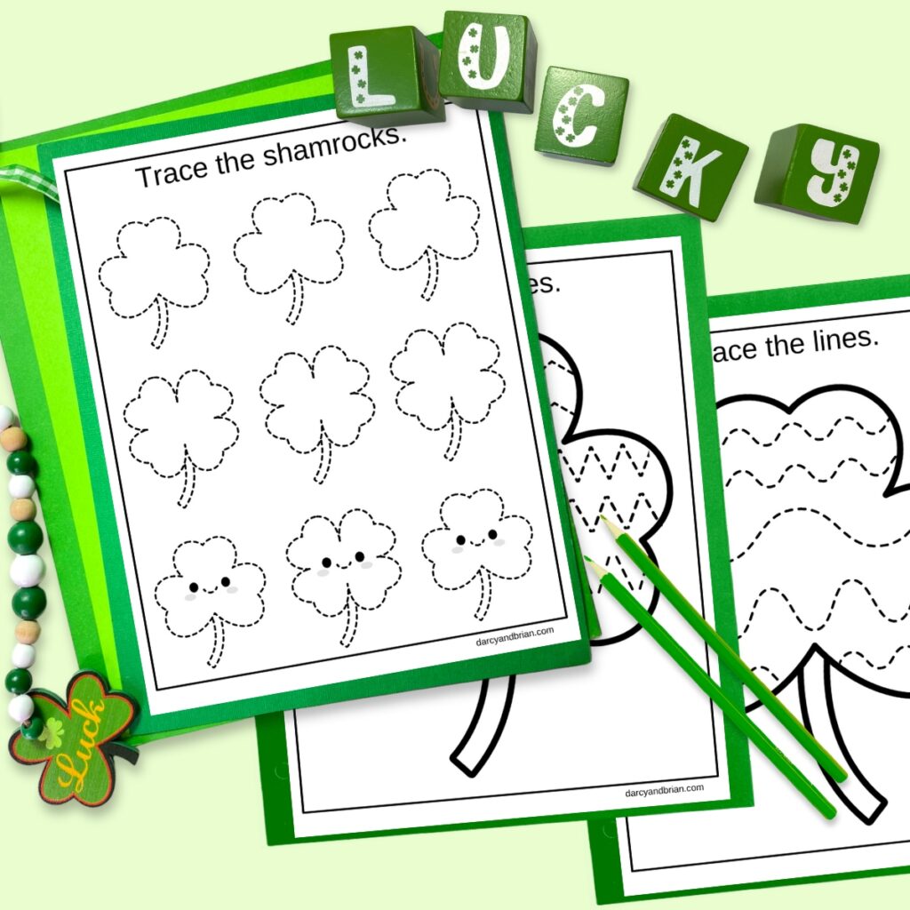Digital mockup of pages to practice tracing shamrock shapes and lines on a light green background. Green blocks that spells lucky and green pencils decorate the space.