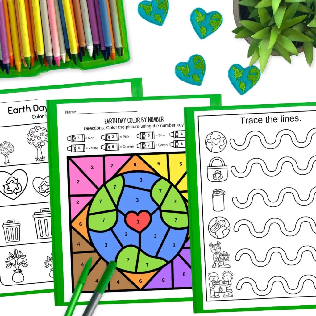Digital mock up of big and small worksheet, full color Earth color by number page, and wavy line tracing page. Crayons, a plant, and little decorative earths around the pages.
