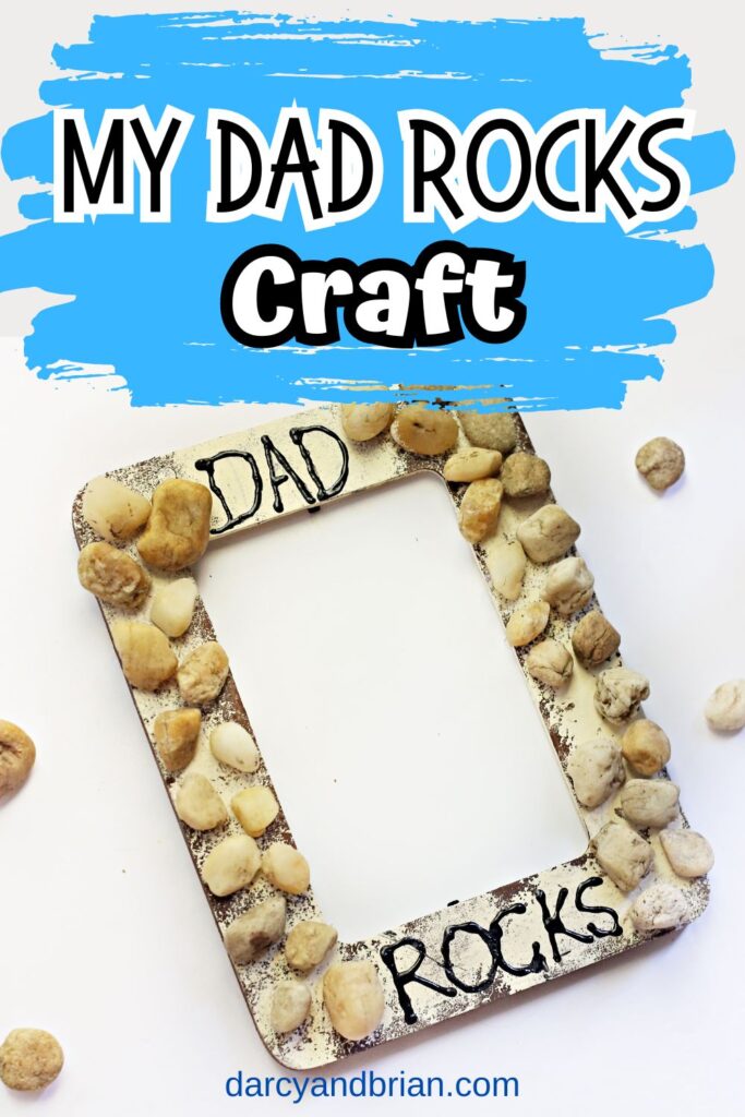Top of image says My Dad Rocks Craft on blue background. Below is a photo of a wooden frame craft made with paint and gluing various stones on it.