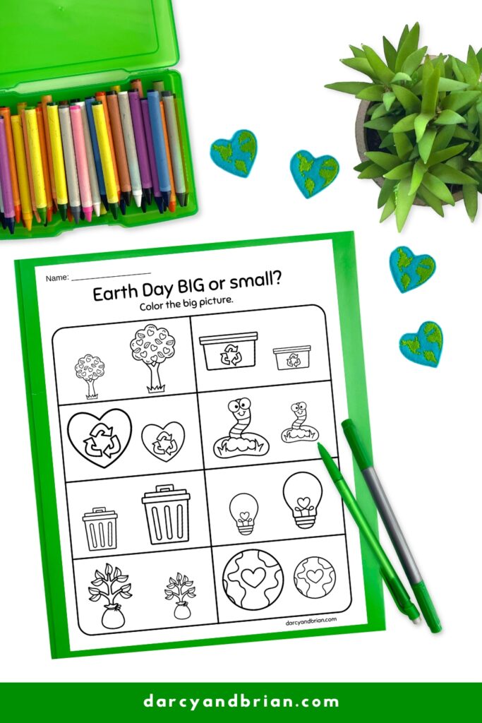 Big or small worksheet with Earth Day themed images. Paper on a green paper with pens, crayons and plant around it.