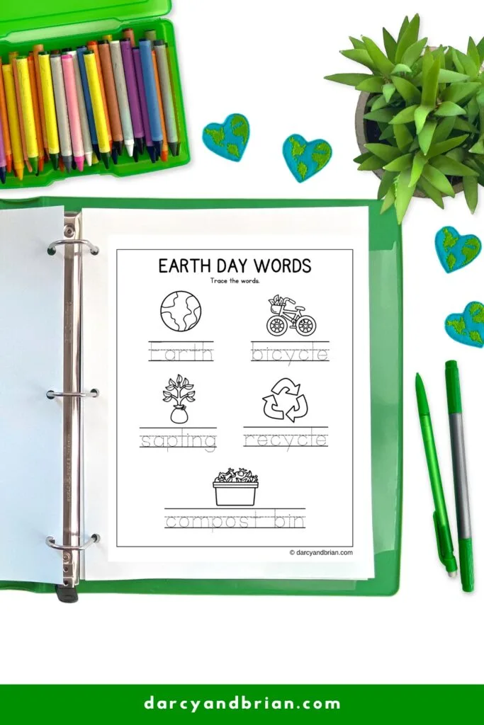 Earth Day words worksheet with dashed words for tracing and accompanying picture. Page in binder next to green pen.