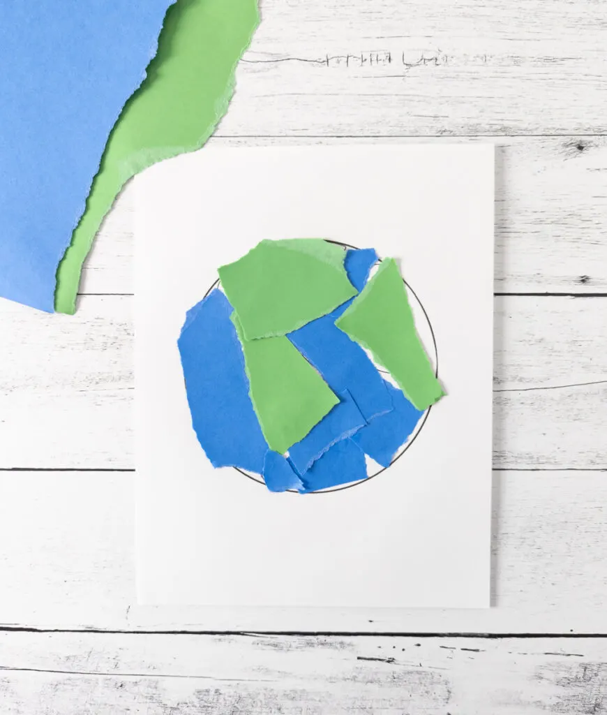 Earth craft for toddlers made with ripped pieces of paper.