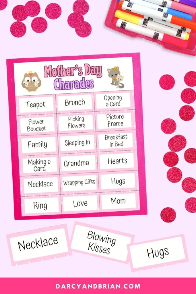 One page of charade word cards on a pink background. Three individual cards overlapping at the bottom that say necklace, blowing kisses, and hugs.