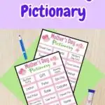 Two pages of Pictionary word cards overlapping on a green paper on a desk. Marker and sand timer laying next to the pages. At the top is dark purple text outlined in white that says Mother's Day Pictionary on a light purple background.