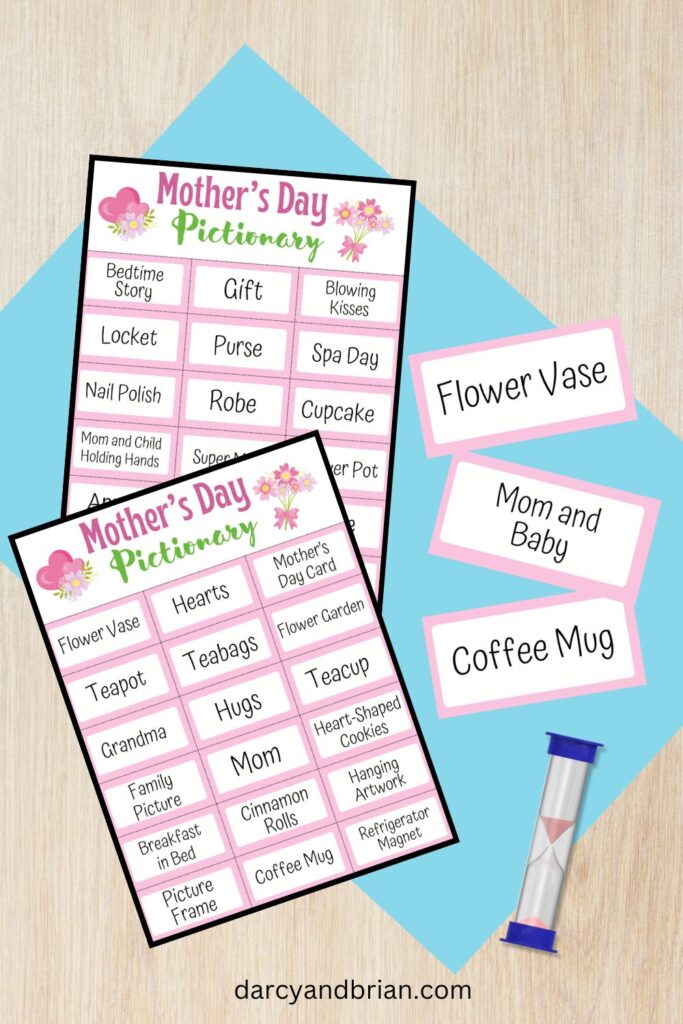 Mother's Day Pictionary word list pages overlapping each other. Three game cards lay next to them with a sand timer on a table.