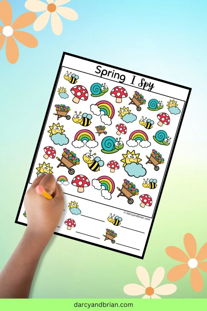 One page with six spring objects to find and count. Includes rainbows, bees, snails, mushrooms, wheelbarrow with flowers. Kid's hand holding a pencil over the worksheet.