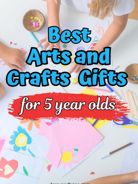 Blue and white text says Best Arts and Crafts Gifts for 5 year olds over a photo of a child's hands cutting and gluing pieces of paper to make flowers.