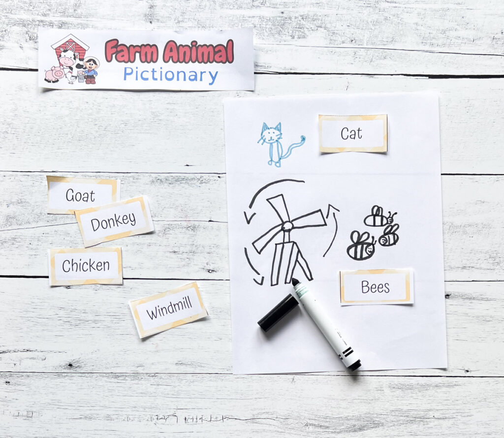 Drawing prompts about the farm laying on table next to drawings of a cat, bees, and a windmill.