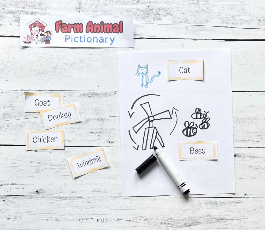 Drawing prompts about the farm laying on table next to drawings of a cat, bees, and a windmill.