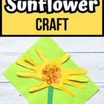 Black and white text on yellow background at the top says Handprint Sunflower Craft. A sunflower made using construction paper and tracing hands for petals laying on bright green paper.