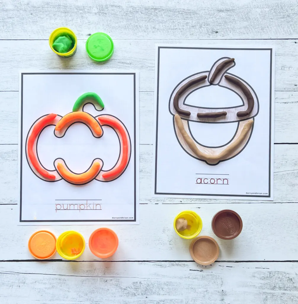 Pumpkin and acorn printable playdough mats laying side by side. Orange and green dough on the pumpkin and two different browns on the acorn.